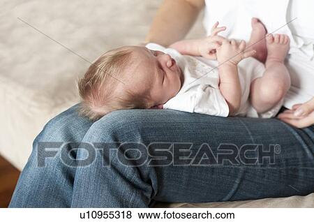 Stock Photo - Mother holding infant son on lap. Fotosearch
