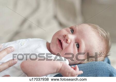 Stock Photo - Mother holding infant son on lap. Fotosearch