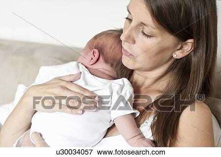 Mother holding infant son View Large Photo Image Stock Photo - Mother holding infant son. Fotosearch