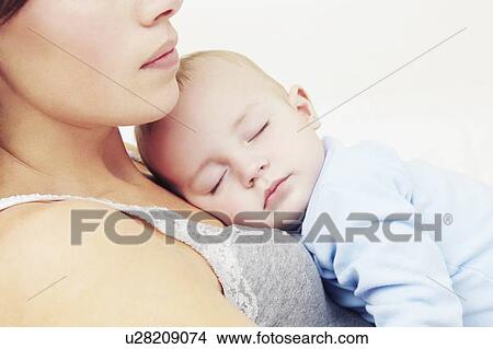 Picture - Mother holding sleeping baby girl. Fotosearch