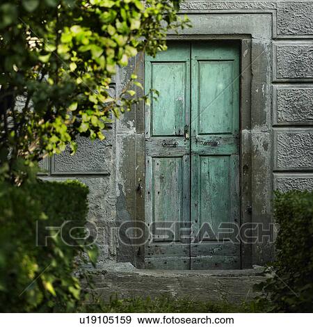 Stock Photo - Old doors in concrete wall. Fotosearch