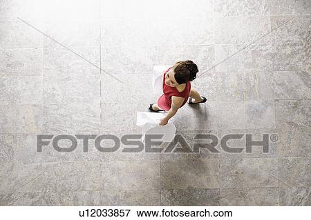 Stock Photo - Overhead view of businesswoman walking. Fotosearch