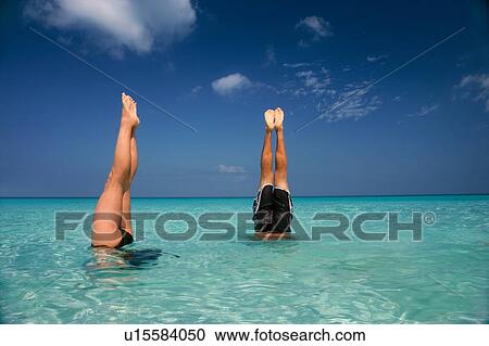 People in headstands in tropical water View Large Photo Image Stock Image - People in headstands in tropical water. Fotosearch
