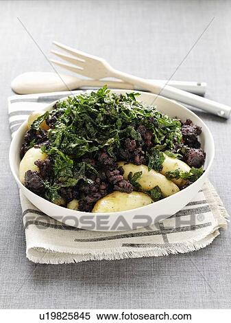 Stock Photography - Plate of potatoes, sausage and parsley. Fotosearch