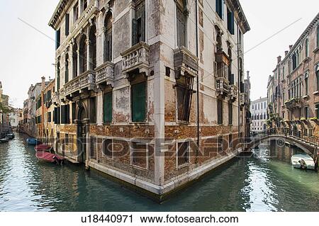 Rowboats and buildings on urban canal View Large Photo Image Stock Image - Rowboats and buildings on urban canal. Fotosearch