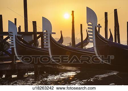 Stock Image - Rowboats docked in harbor. Fotosearch