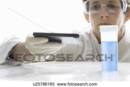 Stock Photography - Scientist using cell phone in lab. Fotosearch