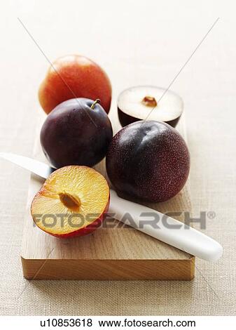 Sliced plums on cutting board View Large Photo Image Stock Photo - Sliced plums on cutting board. Fotosearch