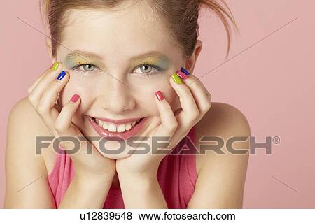 Stock Photo - Smiling girl wearing colorful makeup. Fotosearch