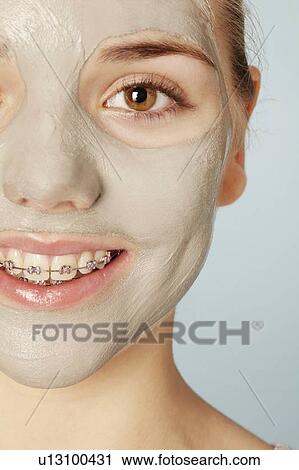 Stock Image - Smiling girl wearing face mask. Fotosearch