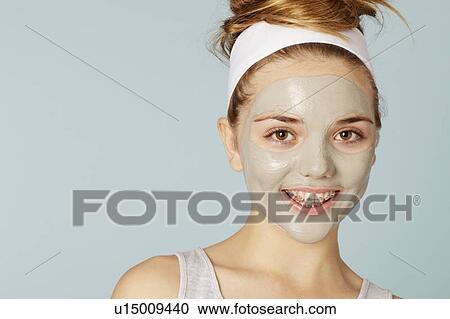 Stock Image - Smiling girl wearing face mask. Fotosearch