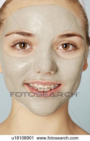 Stock Image - Smiling girl wearing face mask. Fotosearch