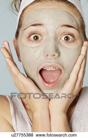 Stock Photo - Smiling girl wearing face mask. Fotosearch