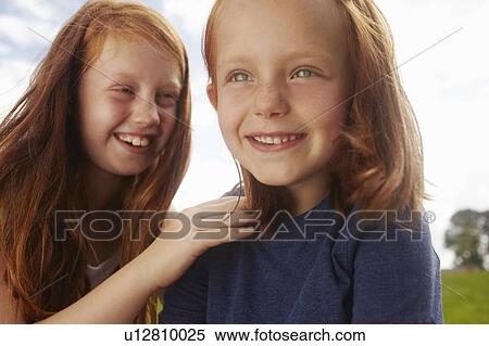 Stock Photography - Smiling girls playing outdoors. Fotosearch