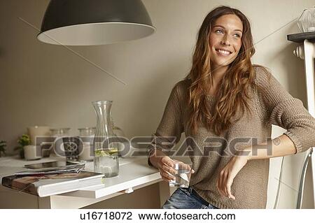 Smiling woman having glass of water View Large Photo Image Stock Image - Smiling woman having glass of water. Fotosearch
