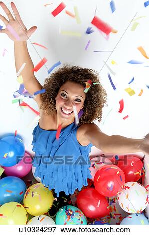 Smiling woman in confetti and balloons View Large Photo Image Stock Photo - Smiling woman in confetti and balloons. Fotosearch