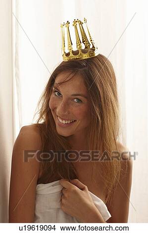 Picture - Smiling woman in sheet wearing crown. Fotosearch
