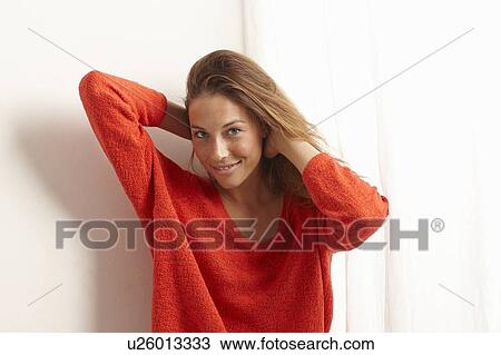 Smiling woman playing with her hair View Large Photo Image Stock Image - Smiling woman playing with her hair. Fotosearch