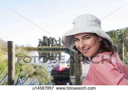 Stock Photo - Smiling woman sitting outdoors. Fotosearch