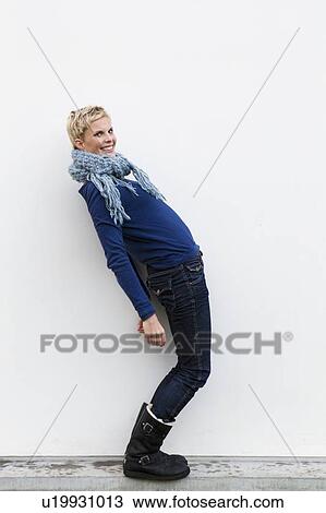 Stock Image - Smiling woman standing outdoors. Fotosearch