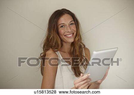 Smiling woman using tablet computer View Large Photo Image Stock Photo - Smiling woman using tablet computer. Fotosearch
