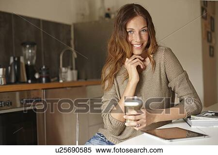 Smiling woman using tablet computer View Large Photo Image Stock Photography - Smiling woman using tablet computer. Fotosearch