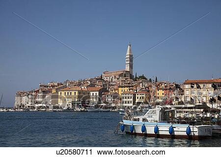 Stock Image - Tower over village and waterfront. Fotosearch