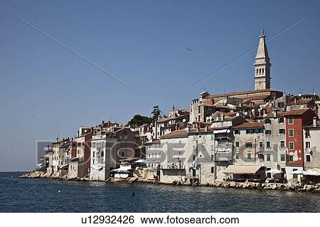 Stock Photograph - Tower over village and waterfront. Fotosearch