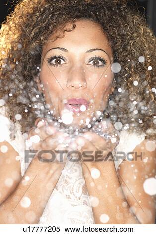 Woman blowing confetti from hands View Large Photo Image Stock Photography - Woman blowing confetti from hands. Fotosearch