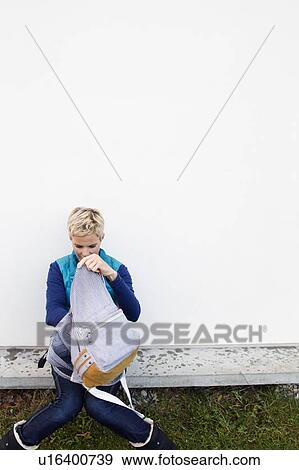 Woman digging through backpack View Large Photo Image Stock Photo - Woman digging through backpack. Fotosearch