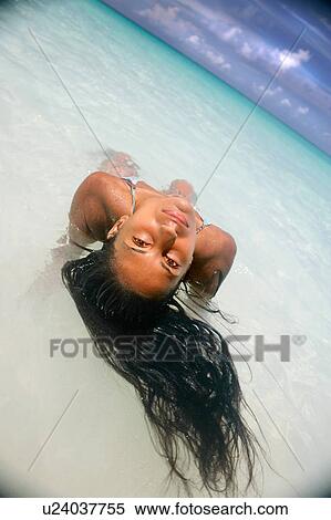Woman floating in tropical water View Large Photo Image Stock Photography - Woman floating in tropical water. Fotosearch