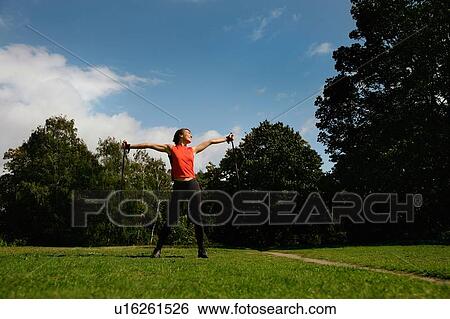 Stock Photograph - Woman hiking in park. Fotosearch