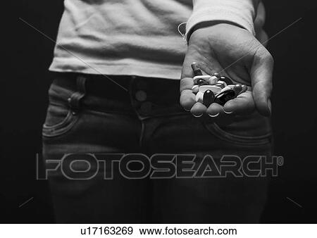 Woman holding handful of pills View Large Photo Image Stock Photo - Woman holding handful of pills. Fotosearch