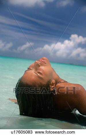 Woman laying on tropical beach View Large Photo Image Stock Image - Woman laying on tropical beach. Fotosearch