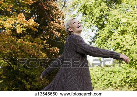 Woman playing in park View Large Photo Image Stock Image - Woman playing in park. Fotosearch