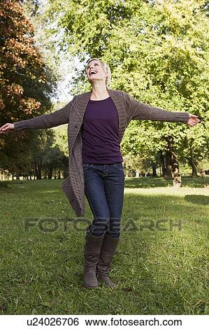 Stock Photograph - Woman playing in park. Fotosearch
