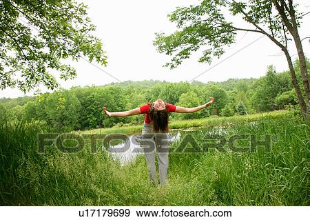 Woman practicing yoga by rural lake View Large Photo Image Stock Photo - Woman practicing yoga by rural lake. Fotosearch