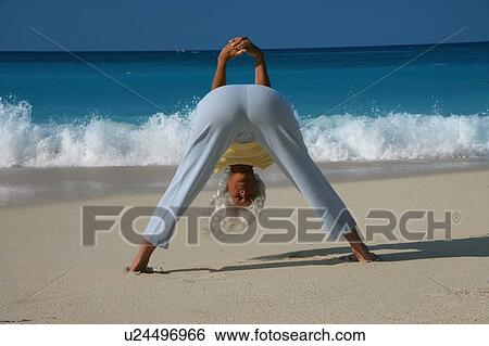 Woman practicing yoga on tropical beach View Large Photo Image Stock Photograph - Woman practicing yoga on tropical beach. Fotosearch
