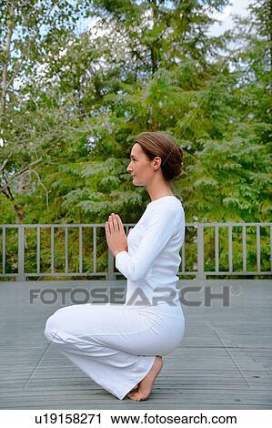 Woman practicing yoga outdoors View Large Photo Image Stock Image - Woman practicing yoga outdoors. Fotosearch