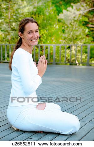 Woman practicing yoga outdoors View Large Photo Image Stock Image - Woman practicing yoga outdoors. Fotosearch