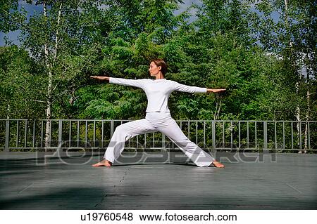 Stock Photo - Woman practicing yoga outdoors. Fotosearch