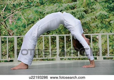 Woman practicing yoga outdoors View Large Photo Image Stock Photograph - Woman practicing yoga outdoors. Fotosearch