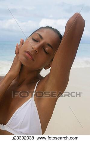 Woman pushing her hair back outdoors View Large Photo Image Stock Photo - Woman pushing her hair back outdoors. Fotosearch