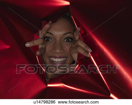 Woman pushing through hole in wall View Large Photo Image Stock Photograph - Woman pushing through hole in wall. Fotosearch