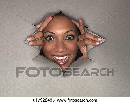Woman pushing through hole in wall View Large Photo Image Stock Photography - Woman pushing through hole in wall. Fotosearch