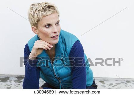 Woman resting chin in hand outdoors View Large Photo Image Stock Image - Woman resting chin in hand outdoors. Fotosearch