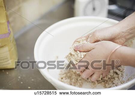 Woman shaping dough in kitchen View Large Photo Image Stock Photography - Woman shaping dough in kitchen. Fotosearch