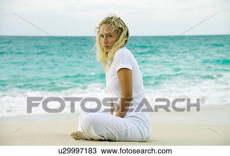 Woman sitting on tropical beach View Large Photo Image Stock Image - Woman sitting on tropical beach. Fotosearch