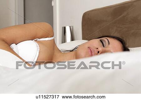 Stock Photo - Woman sleeping in bed. Fotosearch