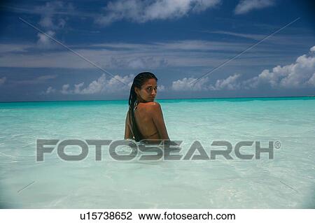 Woman standing in tropical water View Large Photo Image Stock Image - Woman standing in tropical water. Fotosearch